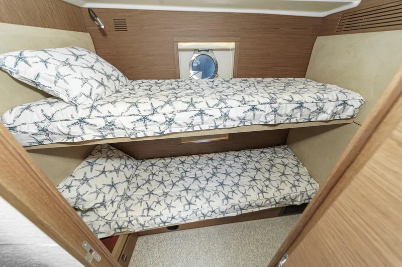 The Riviera Yacht Photos Pics 2017 Monte Carlo MC5S yacht cabin with starfish-patterned bunk beds and porthole window.