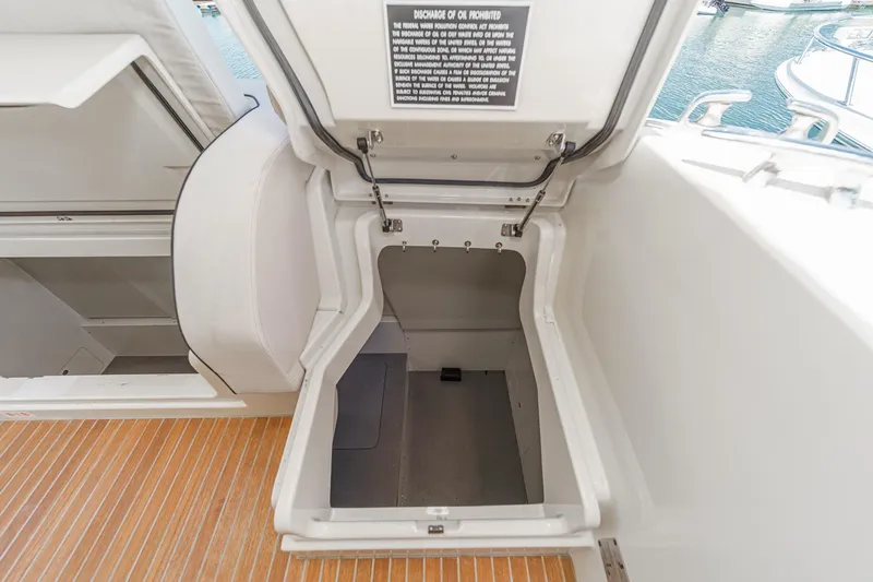 The Riviera Yacht Photos Pics Open storage compartment on 2017 Monte Carlo MC5S yacht, featuring teak flooring.