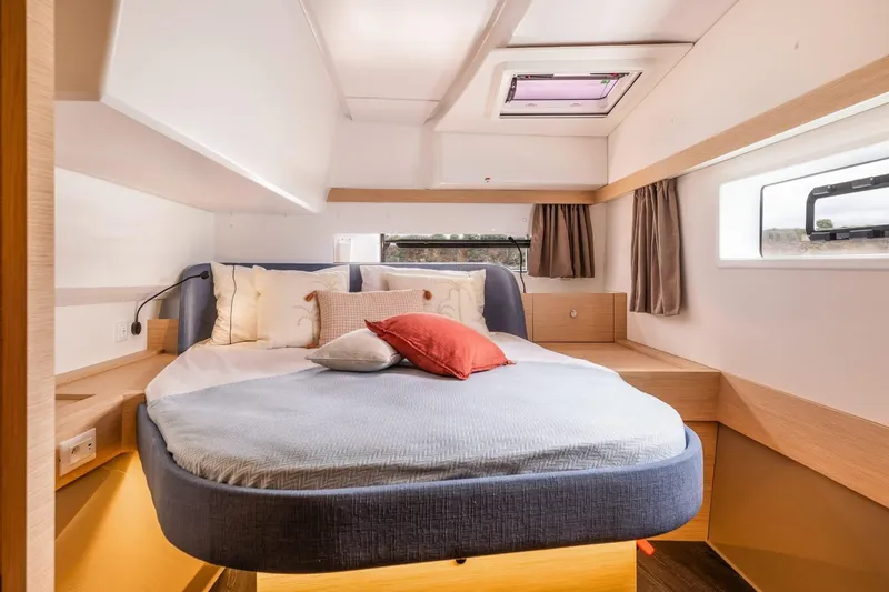  Yacht Photos Pics Luxurious cabin interior of 2025 Fountaine Pajot 41 yacht with cozy bed and modern design.