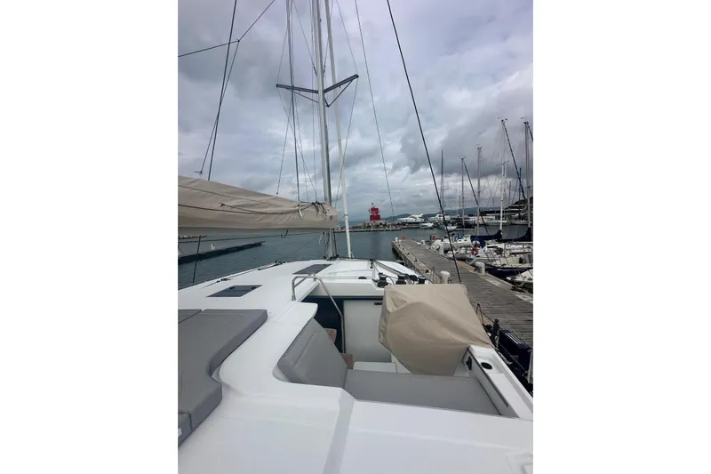  Yacht Photos Pics 2025 Fountaine Pajot 41 yacht docked at marina under cloudy skies.