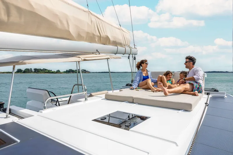  Yacht Photos Pics Family relaxing on 2025 Fountaine Pajot 41 catamaran, enjoying sunny day on the water.