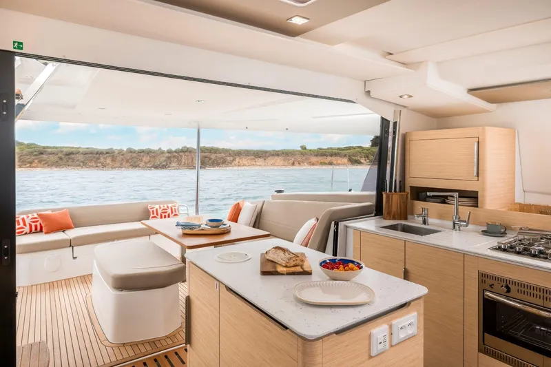  Yacht Photos Pics Luxurious interior of 2025 Fountaine Pajot 41 yacht with modern kitchen and scenic ocean view.