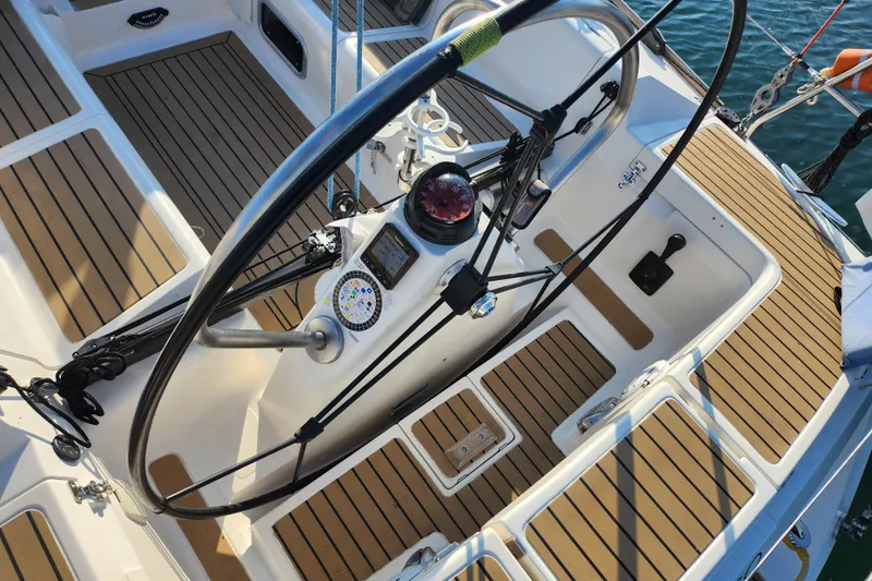 Runaway Yacht Photos Pics Cockpit of a 2005 Elan 40 sailboat with wooden deck and steering wheel.