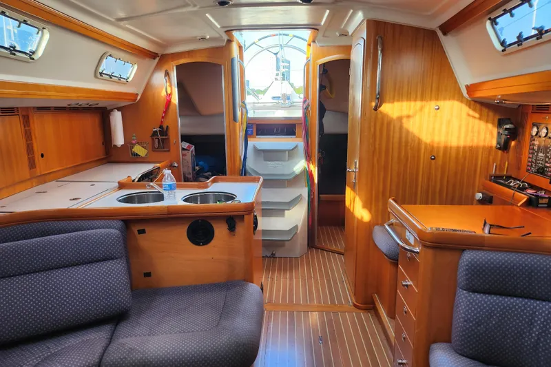 Runaway Yacht Photos Pics Interior of 2005 Elan 40 sailboat with wooden cabinetry and cozy seating.