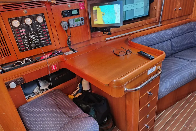 Runaway Yacht Photos Pics Navigation station in 2005 Elan 40 yacht with control panel and seating area.