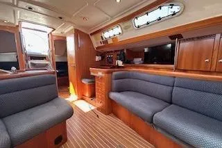 Runaway Yacht Photos Pics Interior of 2005 Elan 40 yacht with wooden finish and comfortable seating.