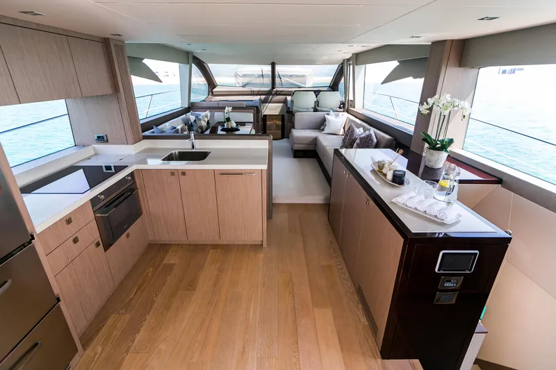 My Serenity Yacht Photos Pics Luxurious interior of 2018 Sunseeker Manhattan 66 yacht with modern kitchen and seating area.