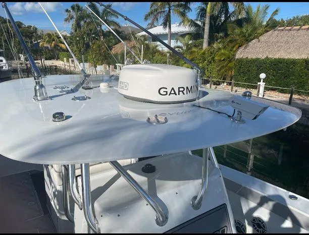  Yacht Photos Pics Freeman 34VH 2020 boat with Garmin radar, docked near tropical foliage.