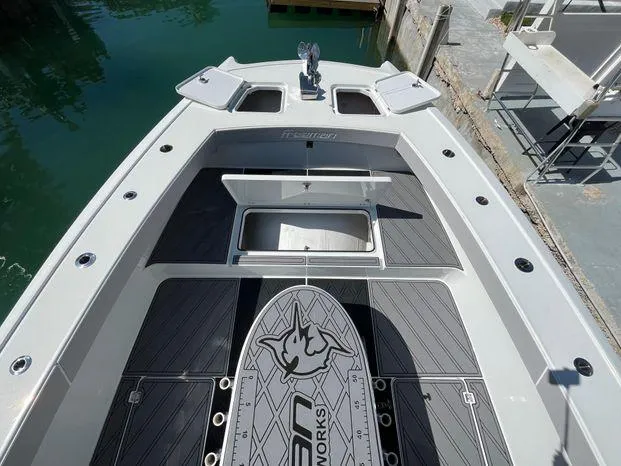  Yacht Photos Pics 2020 Freeman 34VH boat deck with storage compartments and logo, docked by the water.