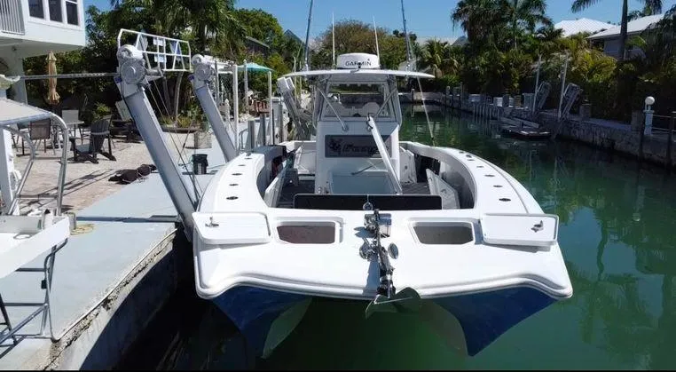  Yacht Photos Pics Freeman 34VH 2020 boat docked in a canal, surrounded by lush greenery.