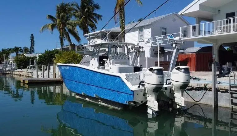  Yacht Photos Pics 2020 Freeman 34VH boat docked by waterfront homes, featuring dual outboard engines.