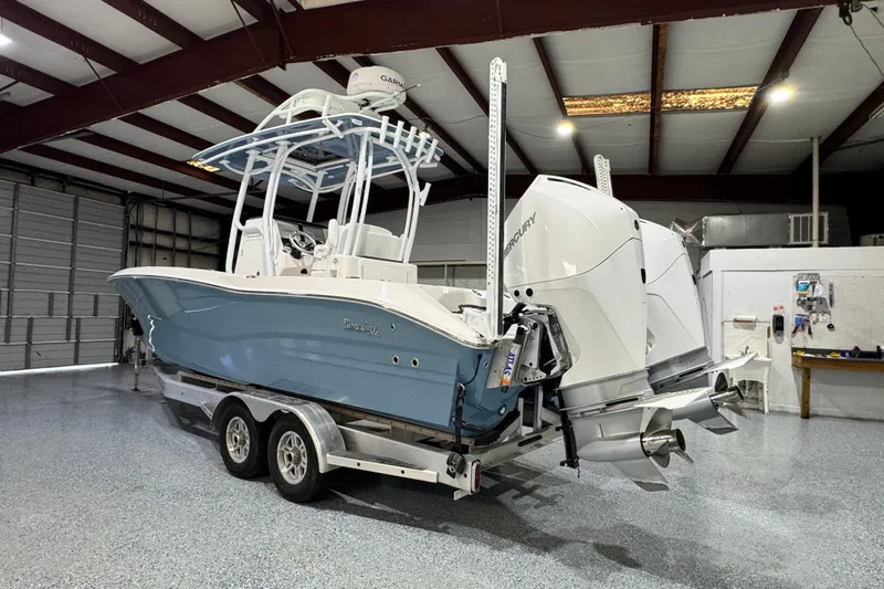  Yacht Photos Pics 2021 Sea Cat 260 boat with dual Mercury engines in a garage setting.