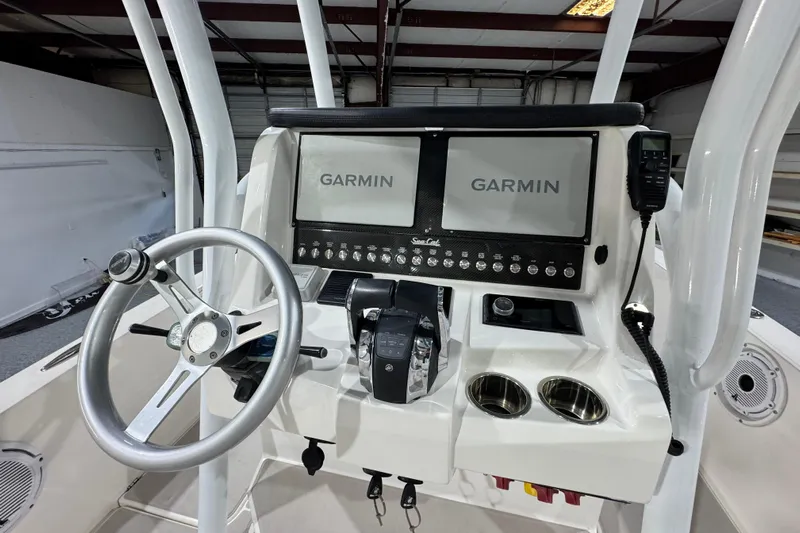  Yacht Photos Pics 2021 Sea Cat 260 helm with dual Garmin displays and steering wheel in a boat interior.