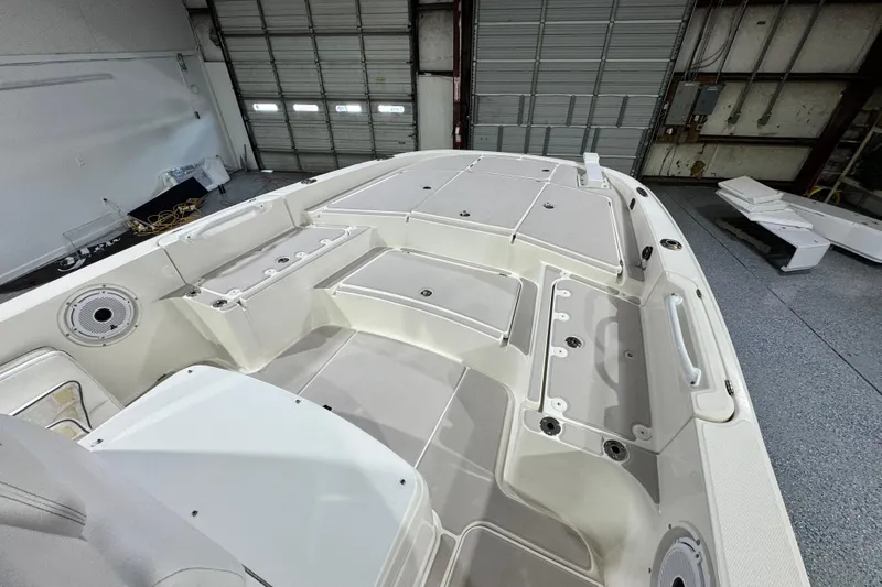  Yacht Photos Pics 2021 Sea Cat 260 boat interior with spacious deck and storage compartments in a garage setting.