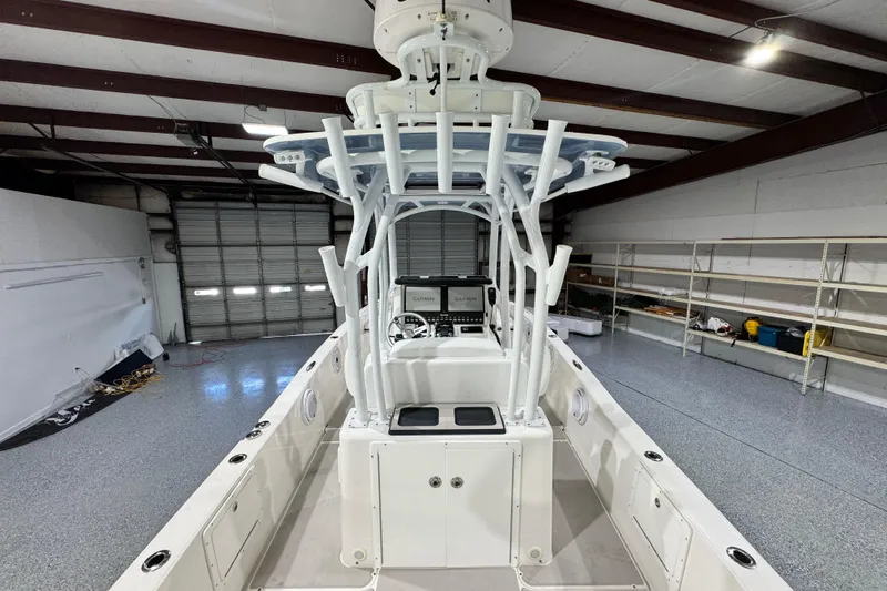  Yacht Photos Pics 2021 Sea Cat 260 boat interior in a spacious garage, showcasing helm and storage.