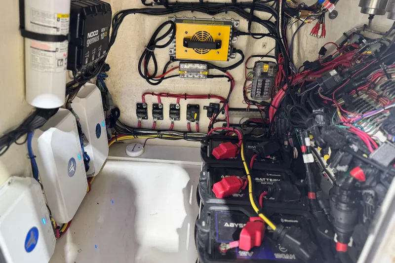  Yacht Photos Pics Electrical system of a 2021 Sea Cat 260 boat, featuring batteries and wiring components.