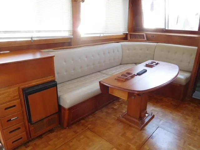 Emily Claire Yacht Photos Pics Interior of 1999 Grand Banks 42 Motoryacht with wooden furnishings and cushioned seating.