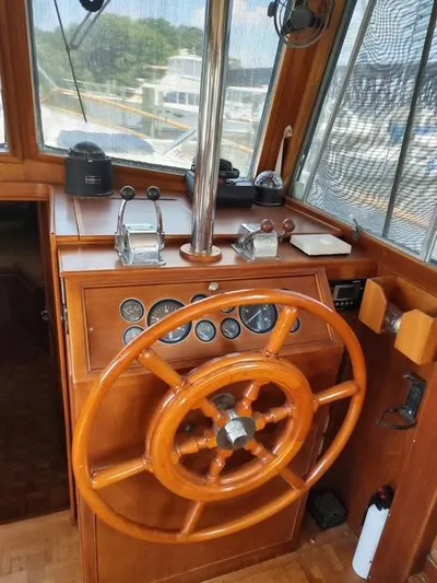 Emily Claire Yacht Photos Pics Helm of 1999 Grand Banks 42 Motoryacht with wooden wheel and control panel.