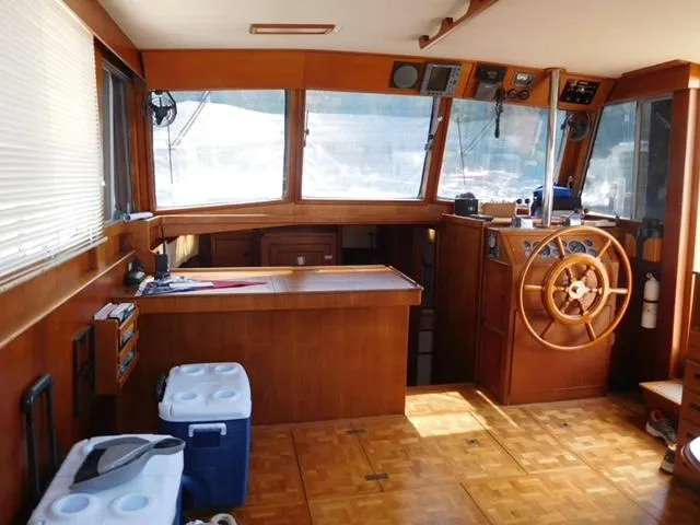 Emily Claire Yacht Photos Pics Interior of 1999 Grand Banks 42 Motoryacht with wooden helm and navigation equipment.