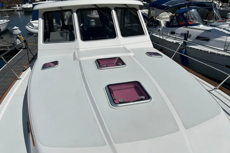  Yacht Photos Pics 2005 Sabre 38 yacht deck with hatches, docked at marina.