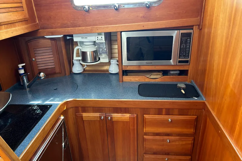 Yacht Photos Pics Wooden yacht galley with microwave, coffee maker, and storage; Sabre 38, 2005 model.