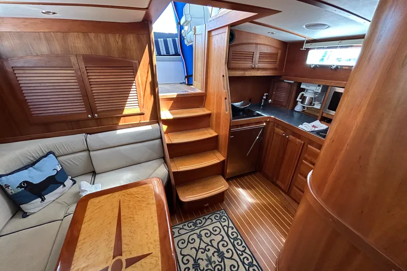  Yacht Photos Pics Luxurious interior of 2005 Sabre 38 yacht with wooden cabinetry and cozy seating area.