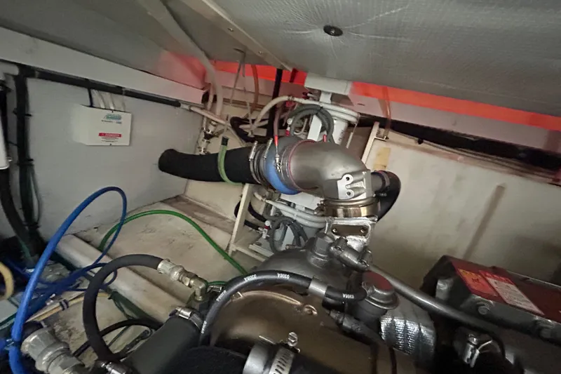  Yacht Photos Pics Engine compartment of a 2005 Sabre 38 boat, featuring hoses and mechanical components.