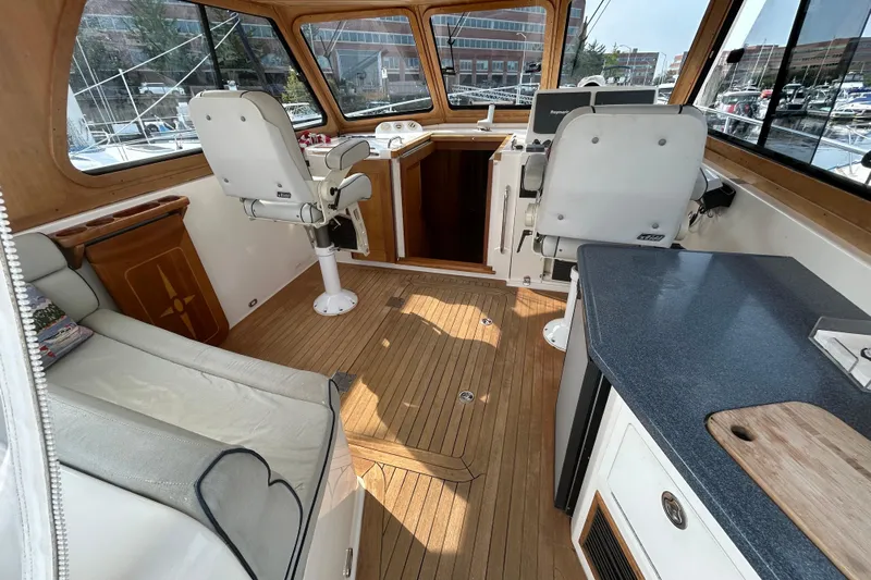  Yacht Photos Pics Interior of 2005 Sabre 38 yacht with wooden flooring and modern helm station.