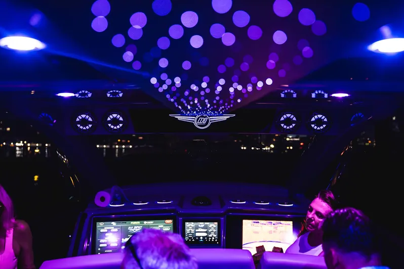  Yacht Photos Pics Interior of 2026 Deep Impact 499 Sport boat with vibrant purple lighting and digital displays.