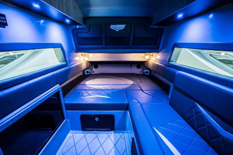  Yacht Photos Pics Luxurious interior of 2026 Deep Impact 499 Sport boat with blue ambient lighting.