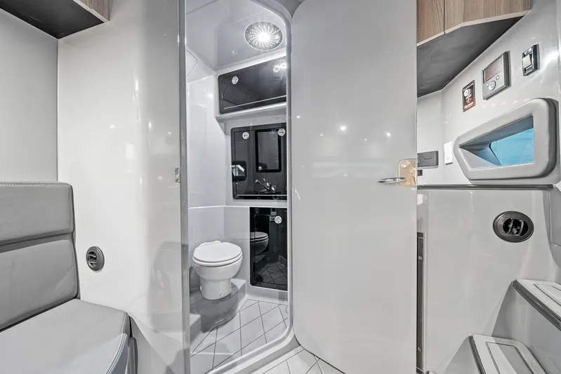  Yacht Photos Pics Modern bathroom interior in 2026 Deep Impact 499 Sport boat, featuring sleek design and amenities.