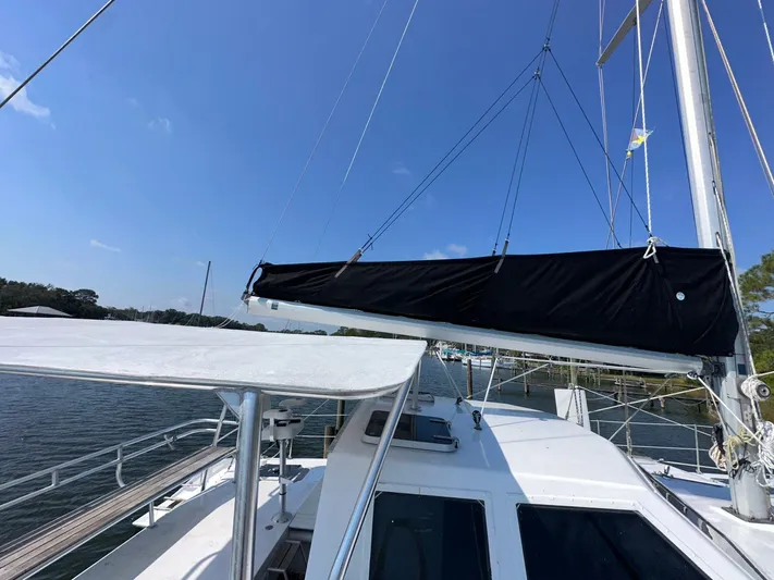 Sola Fide Yacht Photos Pics Sailing yacht deck view, Russell Yachts Crowther 1993, with blue sky and water backdrop.