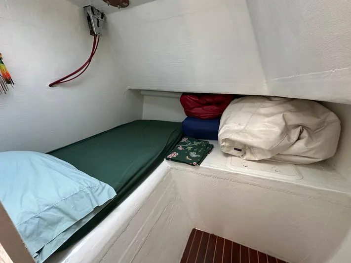 Sola Fide Yacht Photos Pics Cozy cabin interior of 1993 Russell Yachts Crowther, featuring a simple bed setup.