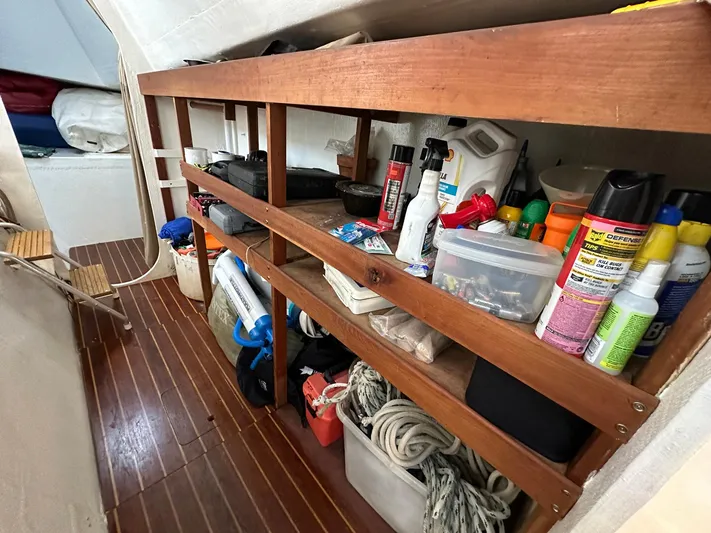Sola Fide Yacht Photos Pics Storage shelves on a 1993 Russell Yachts Crowther, filled with boating supplies and equipment.