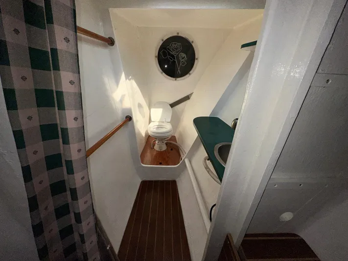 Sola Fide Yacht Photos Pics 1993 Russell Yachts Crowther bathroom with wooden flooring and nautical decor.