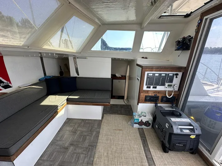 Sola Fide Yacht Photos Pics Interior of 1993 Russell Yachts Crowther with seating, control panel, and generator.