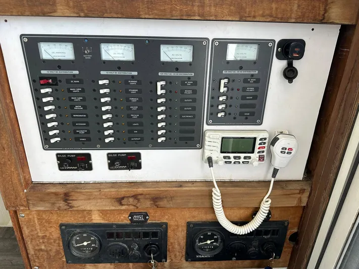 Sola Fide Yacht Photos Pics Control panel of a 1993 Russell Yachts Crowther, featuring gauges and communication equipment.