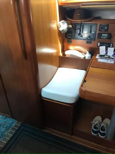  Yacht Photos Pics Interior of 2002 Jeanneau Sun Odyssey 40 sailboat with wooden finish and navigation station.