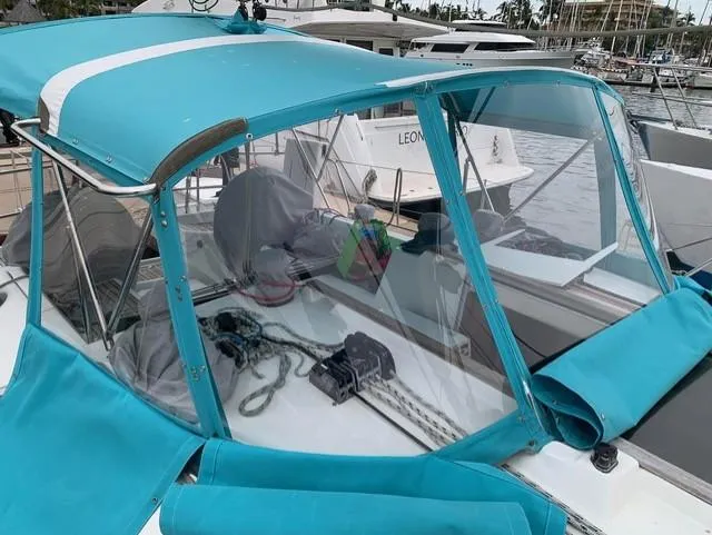  Yacht Photos Pics 2002 Jeanneau Sun Odyssey 40 sailboat with turquoise canopy in marina setting.