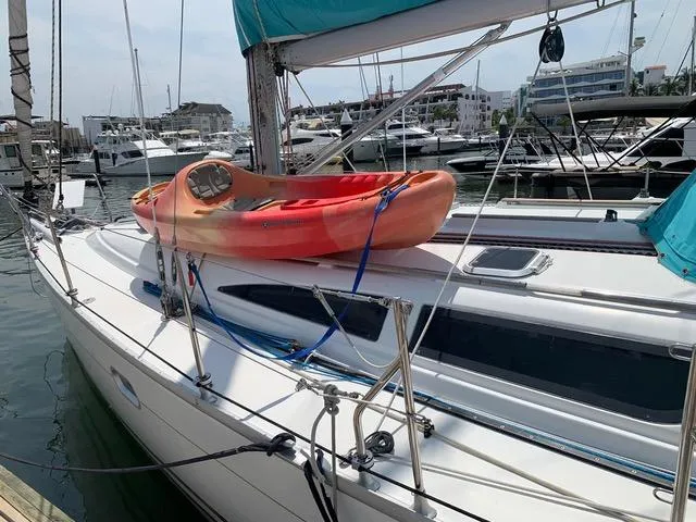  Yacht Photos Pics Jeanneau Sun Odyssey 40 sailboat with kayak on deck, docked in marina, 2002 model.