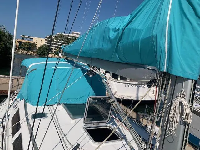  Yacht Photos Pics 2002 Jeanneau Sun Odyssey 40 sailboat with turquoise covers docked in marina.