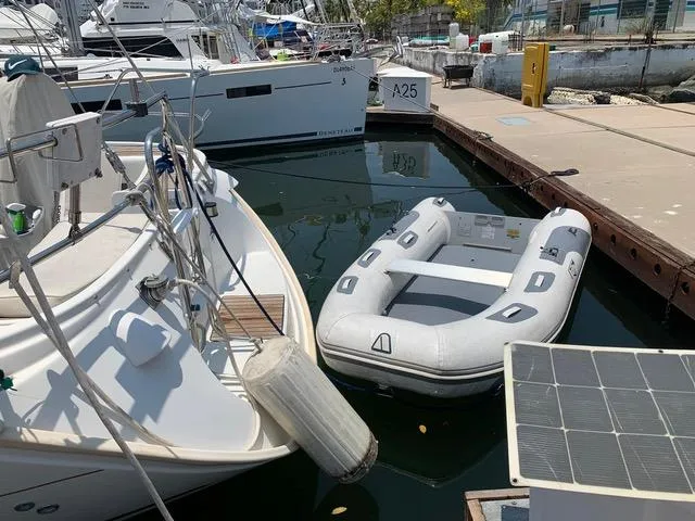  Yacht Photos Pics Docked Jeanneau Sun Odyssey 40 sailboat with inflatable dinghy, 2002 model, marina setting.