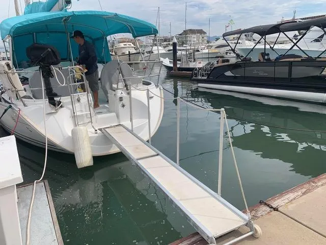  Yacht Photos Pics Jeanneau Sun Odyssey 40 sailboat docked with gangway, 2002 model, marina setting.