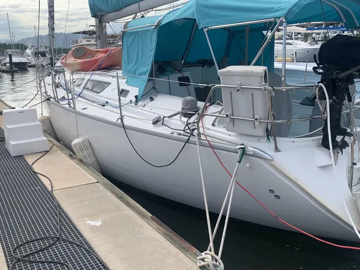  Yacht Photos Pics Jeanneau Sun Odyssey 40 sailboat, 2002 model, docked with blue canopy and equipment.