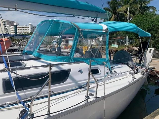  Yacht Photos Pics 2002 Jeanneau Sun Odyssey 40 sailboat with turquoise canopy docked in marina.