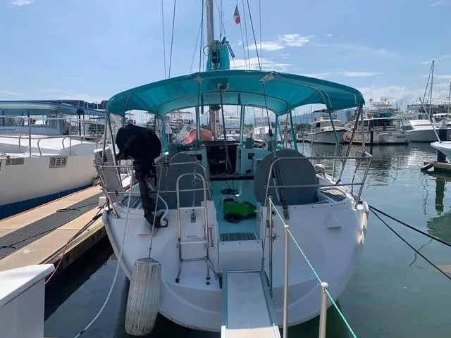  Yacht Photos Pics 2002 Jeanneau Sun Odyssey 40 sailboat docked at marina with turquoise canopy.