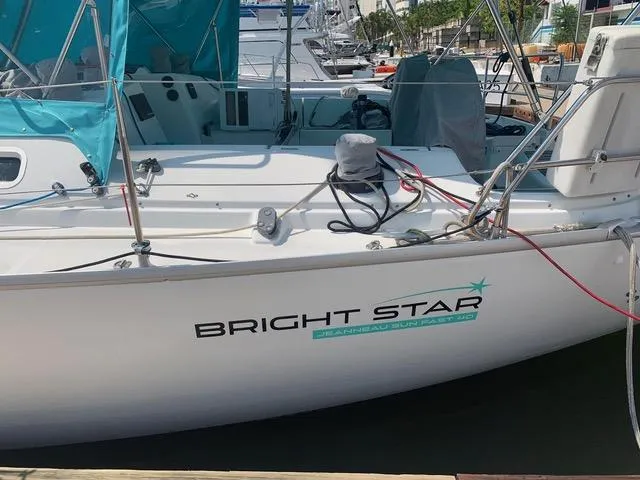  Yacht Photos Pics 2002 Jeanneau Sun Odyssey 40 sailboat named "Bright Star" docked at a marina.