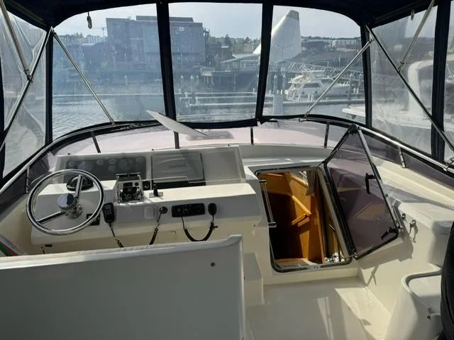  Yacht Photos Pics Interior view of 2000 McKinna 57 Pilothouse yacht cockpit with steering wheel and controls.