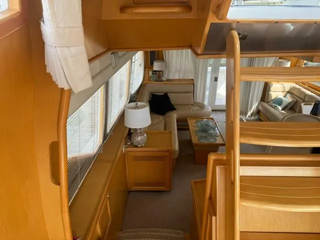  Yacht Photos Pics Interior of 2000 McKinna 57 Pilothouse yacht with elegant wood finish and cozy seating area.
