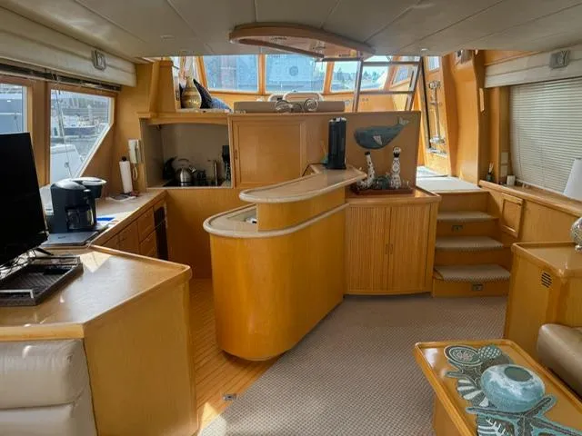  Yacht Photos Pics Interior of 2000 McKinna 57 Pilothouse yacht with modern kitchen and seating area.